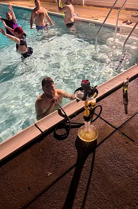 Hookah on the edge of a swimming pool during a summer pool party with hookah rental